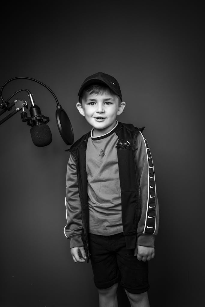 Black and White Photo of a Boy in a Recording Studio