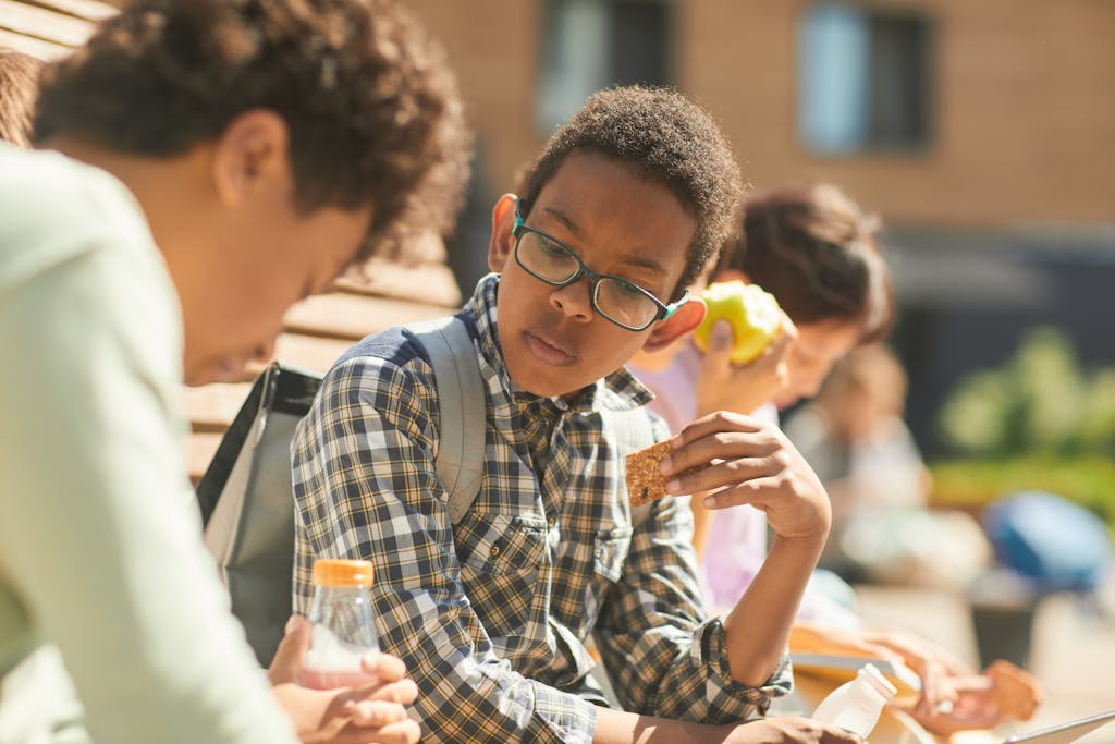 Close-Up Shot of a Boy in Checkered Long Sleeves Wearing Eyeglasses