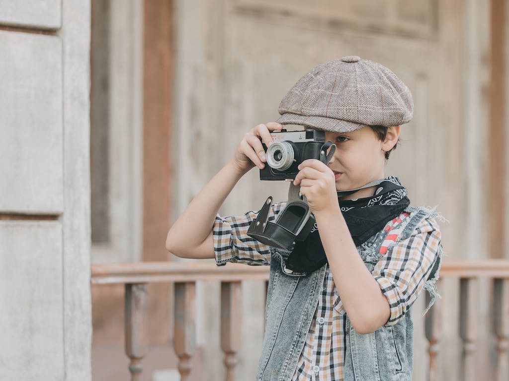Photo Of Boy Holding Camera