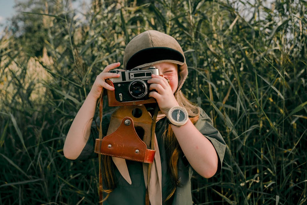 Woman in Brown Hat Holding Black and Silver Camera